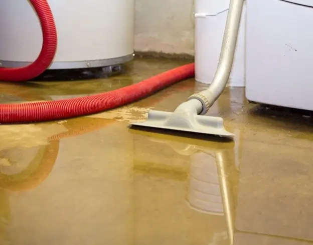 Vacuuming water out of a flooded basement