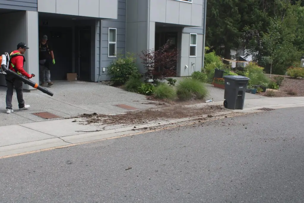 High Point Gutter professional blowing away gutter debris in the Seattle area